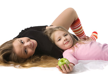 Image showing daughter lies on mum on the floor