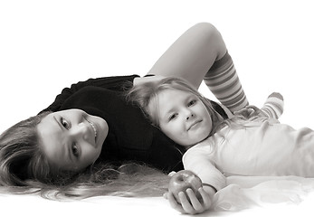 Image showing daughter lies on mum on the floor