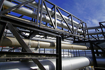 Image showing industrial pipelines on pipe-bridge against blue sky