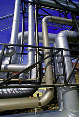 Image showing industrial pipelines on pipe-bridge against blue sky