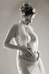 Image showing beautiful pregnant woman, sepia toned