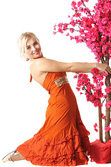 Image showing Woman in orange with tree