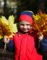 Image showing Happy boy with maple leaves