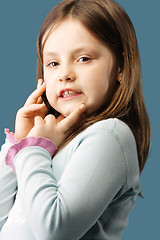 Image showing Little girl with mobile at ear