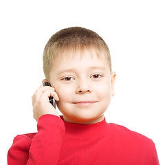 Image showing Little boy with phone at ear