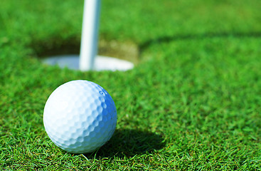 Image showing Golfball in front of the hole