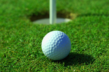 Image showing Golfball in front of the hole