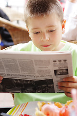 Image showing Boy reading newspaper