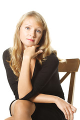 Image showing Young woman in black sitting