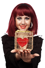 Image showing Happy girl smiling with heart packed in a golden gift box