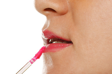 Image showing Applying lipstick