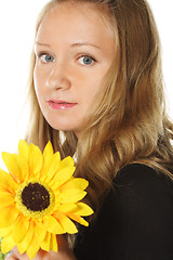 Image showing Woman in black with yellow flower