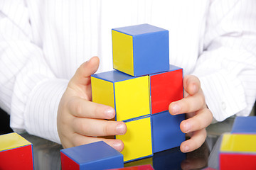 Image showing Hands and color bricks