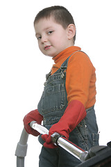 Image showing Funny boy with vacuum cleaner hose