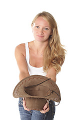 Image showing Smiling girl with hat in hand
