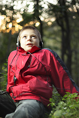 Image showing Boy in forest listening music
