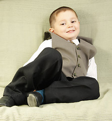 Image showing Smiling boy on sofa