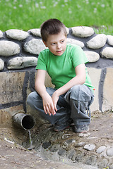 Image showing Boy at spring looking aside