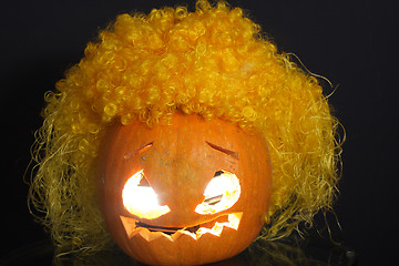 Image showing Halloween pumpkin with yellow curled hairs