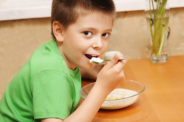 Image showing Boy eating porridge