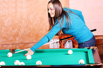 Image showing Woman in blue jumper playing billiards