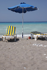 Image showing Two sun-chairs and umbrella