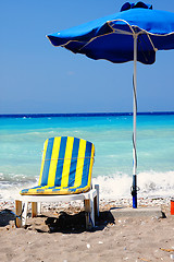 Image showing Striped chair under sunshade