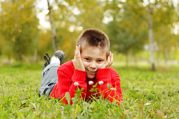 Image showing Boy laying on grass