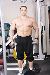 Image showing Big guy with dumbbells
