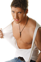 Image showing Guy tearing sleeveless shirt