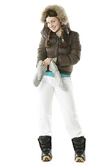 Image showing Snowboarder girl wearing on gloves