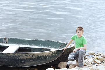 Image showing Boy and old boat