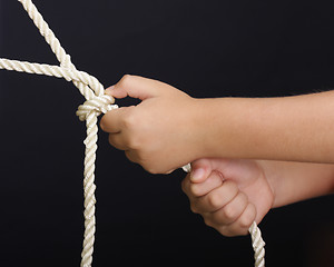 Image showing Hands pulling rope