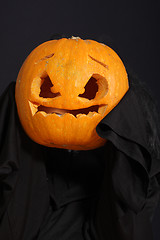Image showing Halloween pumpkin in black robe