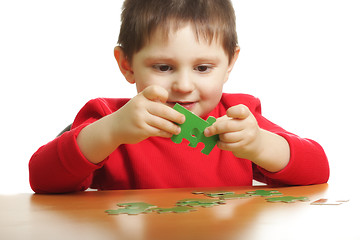 Image showing Boy with green puzzles