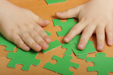 Image showing Puzzles and hands