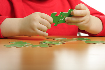 Image showing Hands assembling puzzle