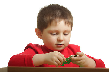 Image showing Boy assembling puzzle