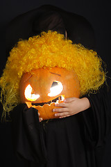 Image showing Curled halloween pumpkin in child hands