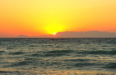 Image showing Sun hiding behind mountain