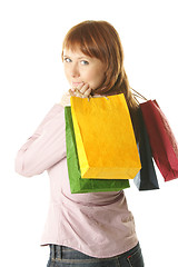 Image showing Redhead girl with colored bags