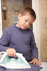 Image showing Ironing boy