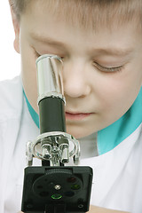 Image showing Looking to microscope