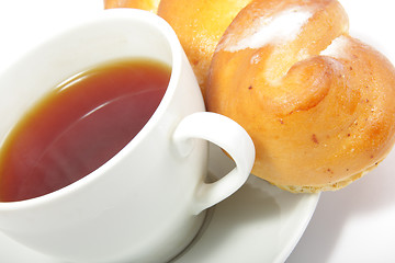 Image showing Tea and bun close-up