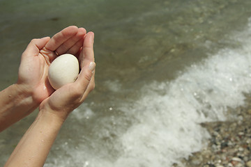 Image showing White stone ball in hands