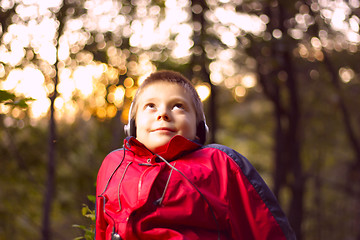 Image showing Boy listening music in forest