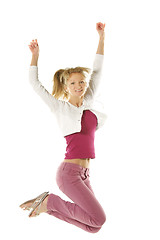 Image showing Jumping girl in pink jeans