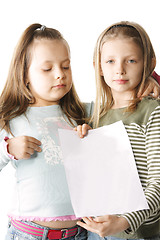 Image showing Two sisters with blank paper