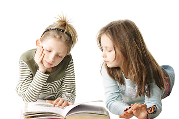 Image showing Two sisters reading book