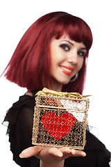 Image showing Happy girl smiling with heart packed in a golden gift box